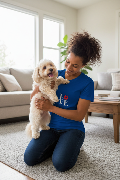 Woman cuddling a small dog at home wearing the Love Dogs blue t-shirt
